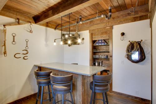 a kitchen with a island with bar stools at Shared Game Room Dazzling Cle Elum Home in Ronald