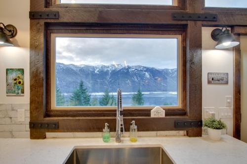 a kitchen sink with a large window above it at Shared Game Room Dazzling Cle Elum Home in Ronald