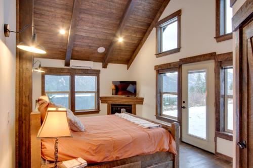 a bedroom with a bed in a room with windows at Dazzling Cle Elum Home with Game Room and Fire Pit! in Ronald