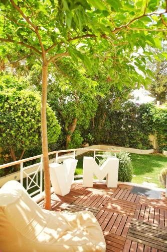 a sign sitting on a patio under a tree at Villa Maria Luisa in Cagliari