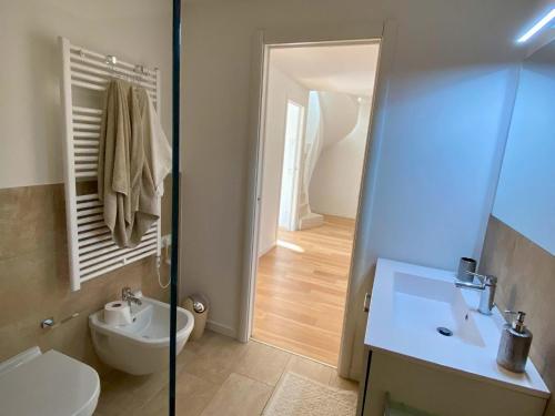 a bathroom with a toilet and a sink and a shower at EnjoyIseoLake - Corinto - wonderful Lake front apartment in Parzanica