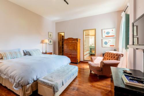 a bedroom with a bed and a living room at Casa Guadalupe in Seville