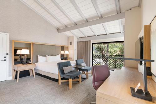 a hotel room with a bed and a tv at Pala Mesa Resort in Fallbrook