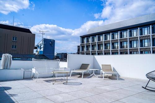 a patio with chairs and tables and a building at Hotel Imagine Kyoto in Kyoto