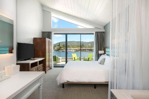 a hotel room with a bed and a view of the water at Lakehouse Resort in San Marcos