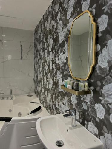 a bathroom with a sink and a mirror on the wall at G Boutique Hotel in Portsmouth