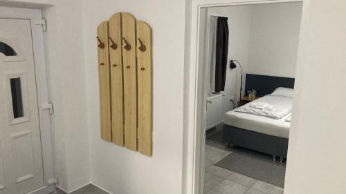 a room with skis on the wall next to a bed at AqFel Airport Apartment in Vecsés