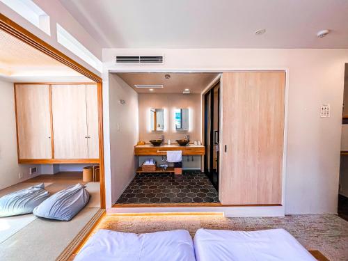 a bedroom with a bathroom with a sink at Hotel Imagine Kyoto in Kyoto