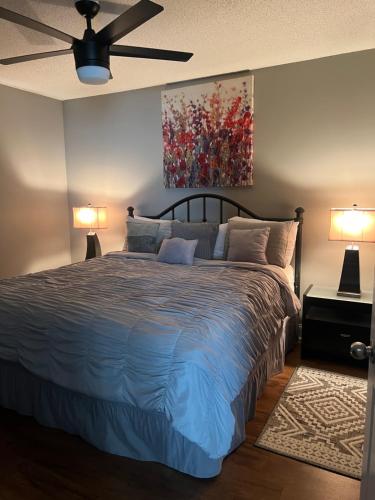 a bedroom with a bed and a painting on the wall at River Place Condos #501 2BD in Pigeon Forge
