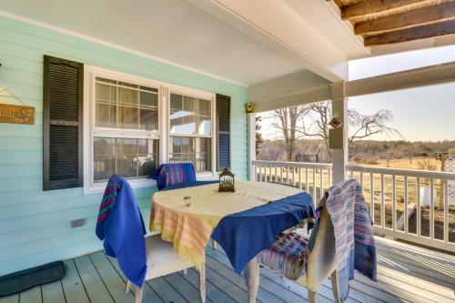 a porch with a table and chairs on a deck at VA Wine and Horse Country Cottage, Near UVA in Ruckersville