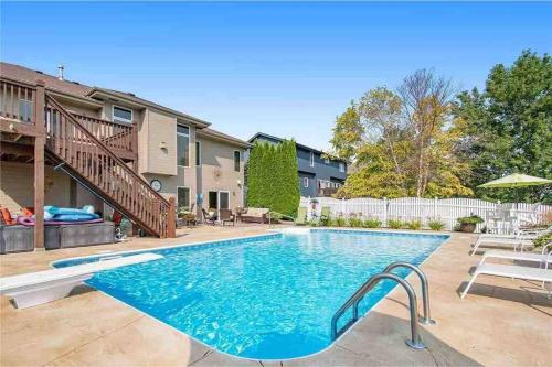 a swimming pool with a slide in a yard at Spacious Pool House with tons of amenities! in Omaha