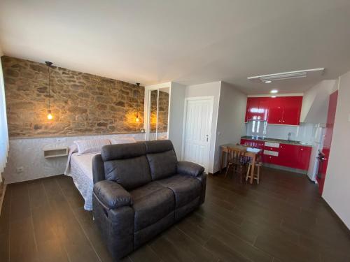 a living room with a couch and a kitchen at Apartamentos Currás en Touriñán in Touriñán