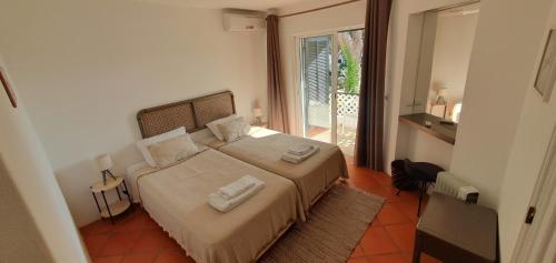 a bedroom with a bed with two towels on it at P209 Balaia Golf Village in Albufeira