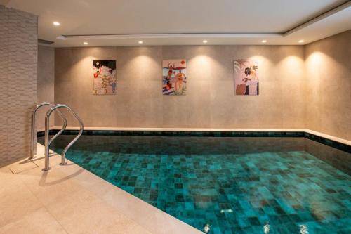 a swimming pool in a building with paintings on the wall at Chalet Yolo in Chandon