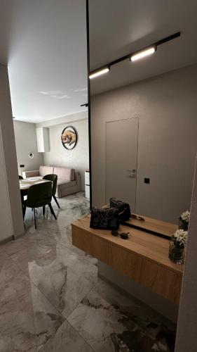 a living room with a table and a dining room at ЦЕНТР ЖК Театральний& АВТО ЖК Great House & ЦЕНТР ЖК Шевченка in Rivne