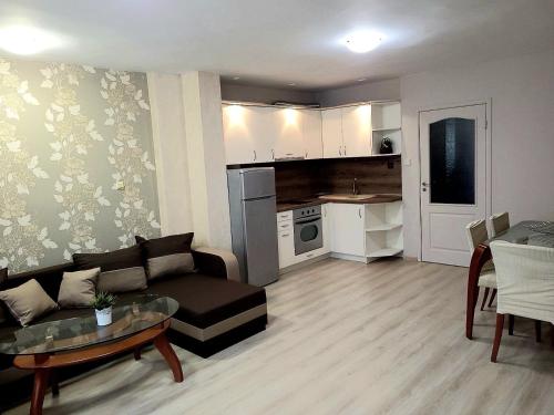 a living room with a couch and a table at Lux Apartment Sisi in Burgas City