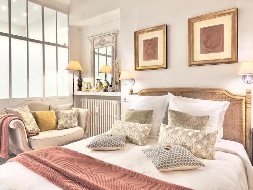 a bedroom with a bed with pillows and a couch at LES ANGES DELUXE AVIGNON - Exclusive Romantic Home - Private Luxury Tours in Avignon