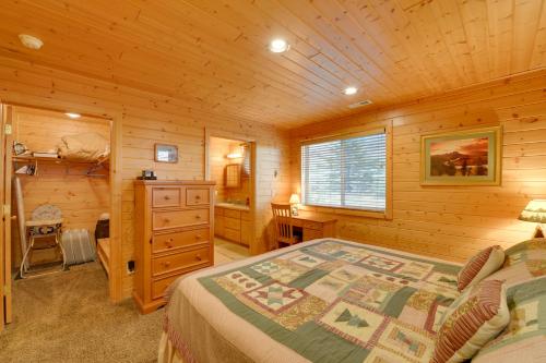 a bedroom with a bed in a wooden cabin at Cozy Henrys Lake Escape - 20 Miles to Yellowstone! in Island Park