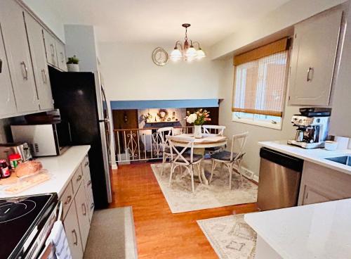 a kitchen with a table and a dining room at Three Bedroom Villa Near Cleveland Clinic, Case Western, University Hospitals in South Euclid