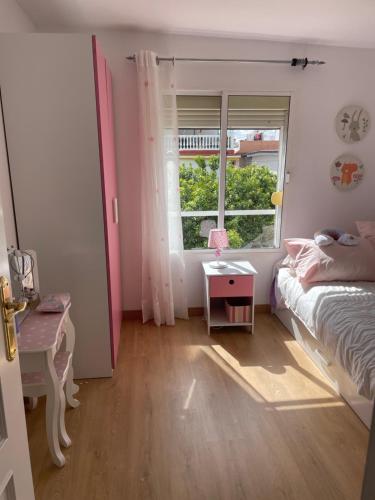 a small bedroom with a bed and a window at Choza Azahares in Santiponce