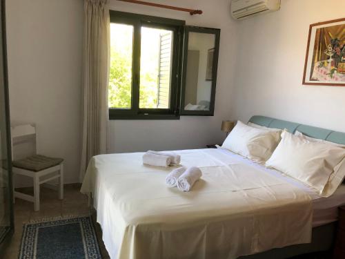 Ένα ή περισσότερα κρεβάτια σε δωμάτιο στο Villa Pefnos