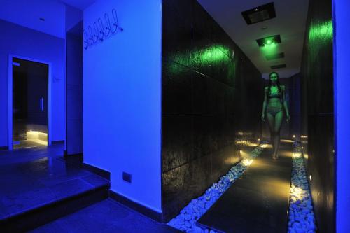 a mannequin is walking down a hallway with a blue light at Piccolo Hotel Aurora in Abbadia San Salvatore