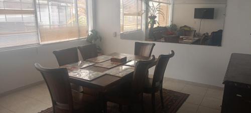 a dining room with a wooden table and chairs at Casa 70 * 7 in Bogotá