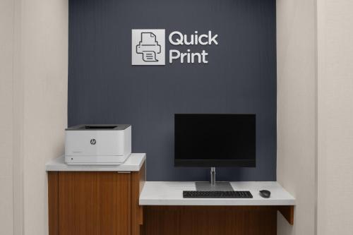 a desk with a computer and a printer on it at Courtyard by Marriott Orem University Place in Orem