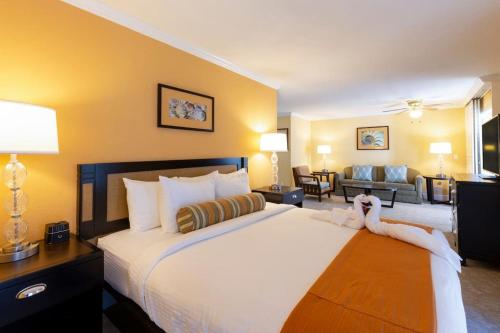 a hotel room with a large bed and a living room at Steps from the beach in Carlsbad- 1 bedroom unit in Carlsbad