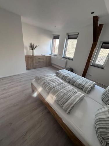 a large white room with two beds and windows at Ferienwohnung in Obernkirchen in Obernkirchen