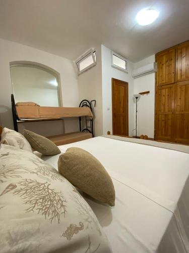 a bedroom with a bed with pillows on it at Villa GAUDÌ in Sant'Isidoro