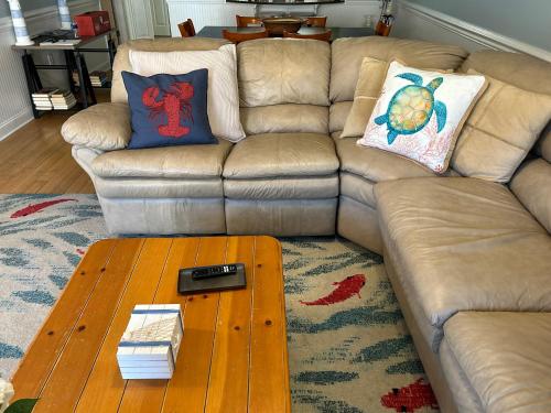a living room with a couch and a coffee table at Unique 3BR, 1 of 5 Condos w/Huge Poolside Patio, Steps to Beach & Pier, Gated in Tybee Island