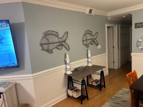 a living room with two fish on the wall at Unique 3BR, 1 of 5 Condos w/Huge Poolside Patio, Steps to Beach & Pier, Gated in Tybee Island