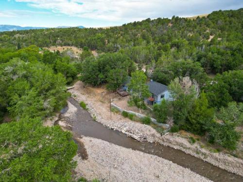an aerial view of a house next to a river at Mountain Home w/ a River in Back - Close to Skiing in Beaver