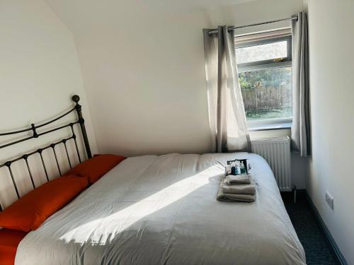 a bed in a bedroom with a window at Apple Yard in Norwich