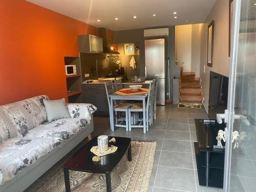 a living room with a couch and a kitchen at Les baux in Les Baux-de-Provence