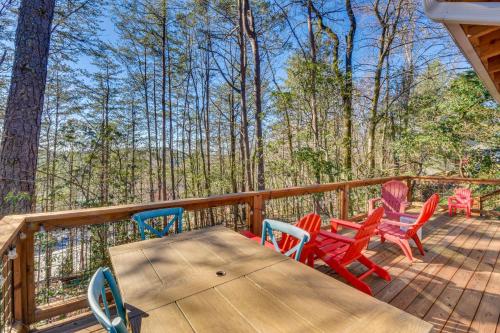 a deck with a wooden table and chairs at Classy Clayton Home with Views Less Than 1 Mi to Downtown! in Clayton