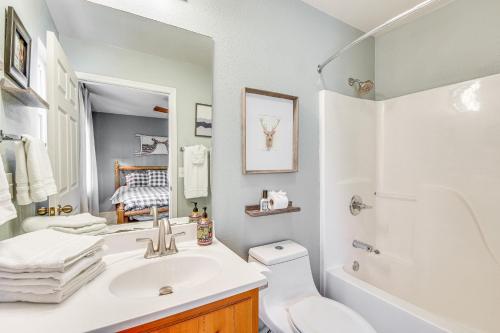 a white bathroom with a sink and a toilet at Classy Clayton Home with Views Less Than 1 Mi to Downtown! in Clayton