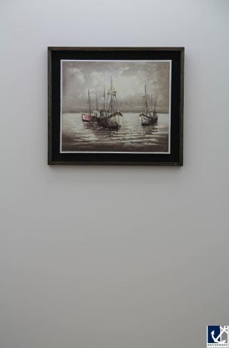 a painting of two ships on the water at Anchorage The Residence in Dhaka