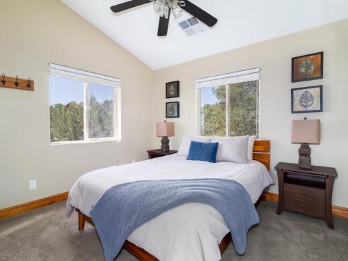a white bedroom with a bed and two windows at Rustic Pine- Secluded Mountain Retreat Near Zion National Park in Orderville