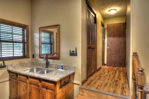 a bathroom with a sink and a wooden floor at Cap's Fishin' Camp #542 in Sevierville