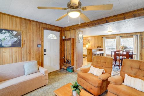 a living room with two chairs and a ceiling fan at Heber Springs Cabin with Deck 3 Mi to Sugarloaf Mtn in Heber Springs
