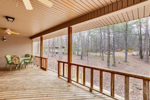 a screened porch with a table and chairs on it at Heber Springs Cabin with Deck 3 Mi to Sugarloaf Mtn in Heber Springs