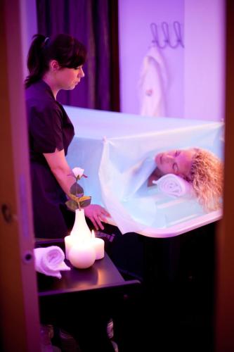 a woman is putting a baby in a crib at Piccolo Hotel Aurora in Abbadia San Salvatore