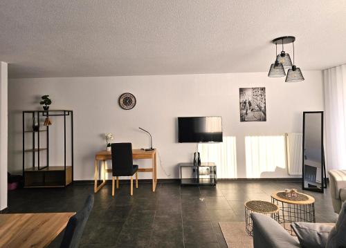 a living room with a table and a desk at MY HOME N 35/6 in Villingen-Schwenningen