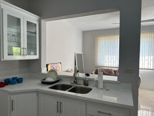 a kitchen with a sink and a counter top at The Shelton - Sinclair in Montego Bay