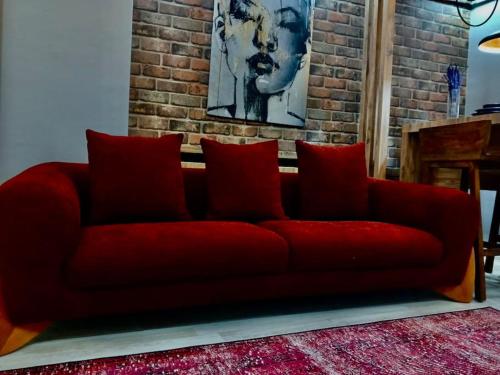 a red couch in a room with a brick wall at Me Van, outstanding, modern and stylish in the city centre in Van