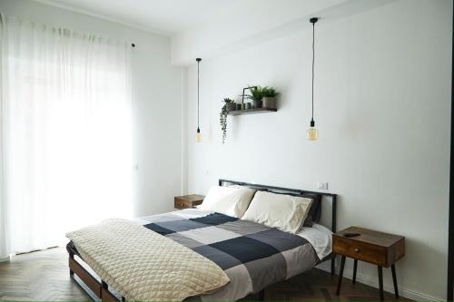 a bedroom with a bed with a black and white blanket at Plebiscito Old Fashion in Castel di Sangro