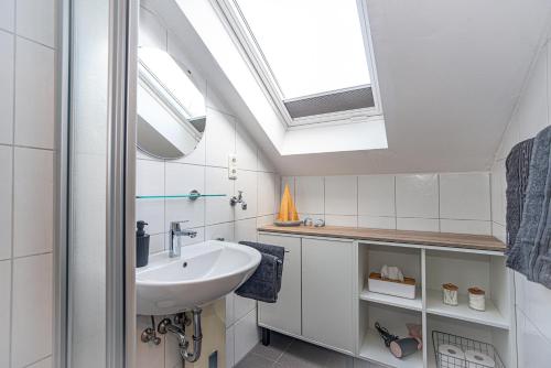 a bathroom with a sink and a skylight at Neue Ferienwohnung in Marl in Marl