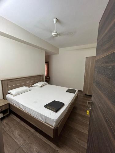 a bedroom with a large bed in a room at The Kaya Guest House Srirangam in Srīrangam